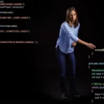 An instructor pointing to some code on a black background.
