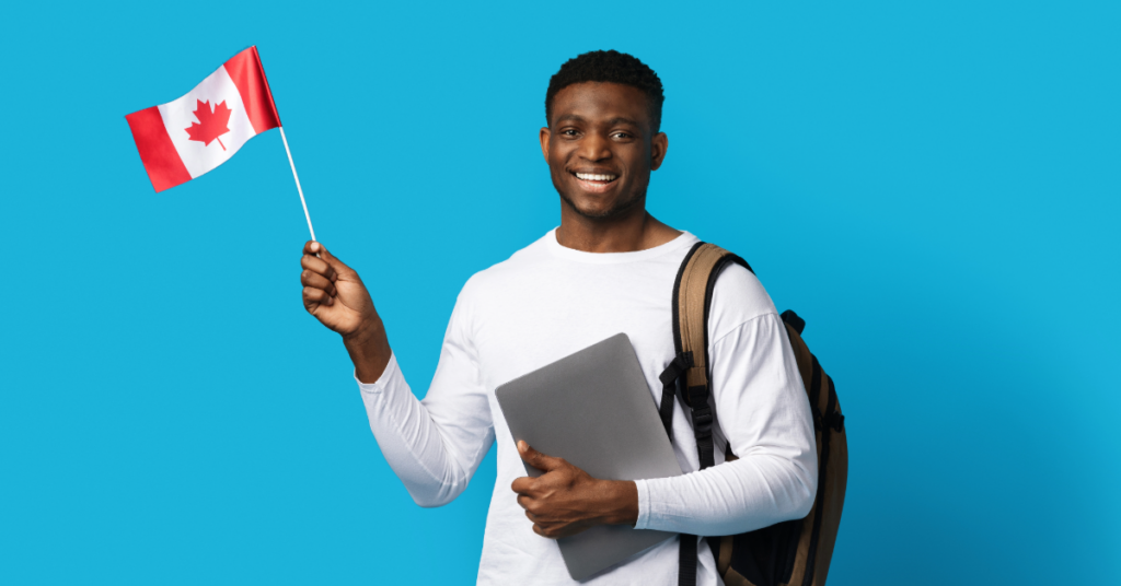 Student wearing a back pack, holding a laptop and a Canadian flag.