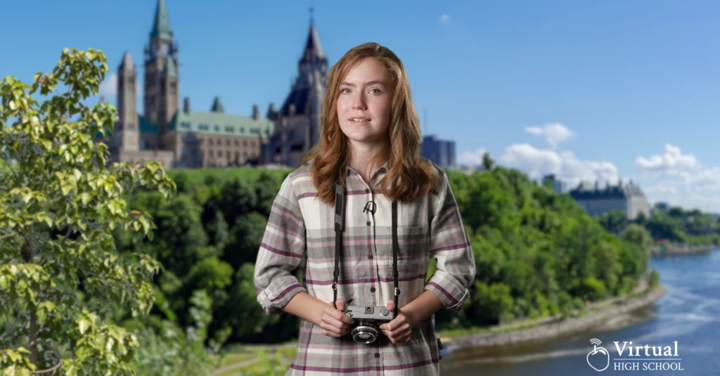 Student holding a camera while travelling to Quebec.