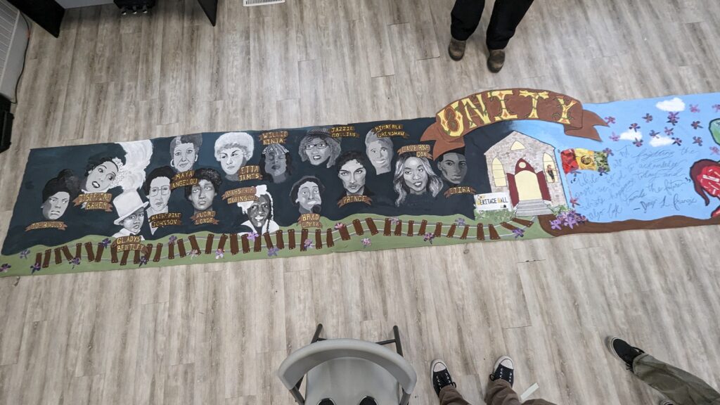 A detail shot on the left side of the mural highlighting Black history and excellence.
